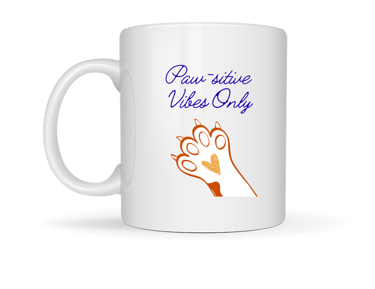 “White ceramic mug with orange and brown paw print and the phrase ‘Paw-sitive Vibes Only’ in cursive script.”