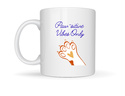 ““White ceramic mug with orange and brown paw print and the phrase ‘Paw‑sitive Vibes Only.’”