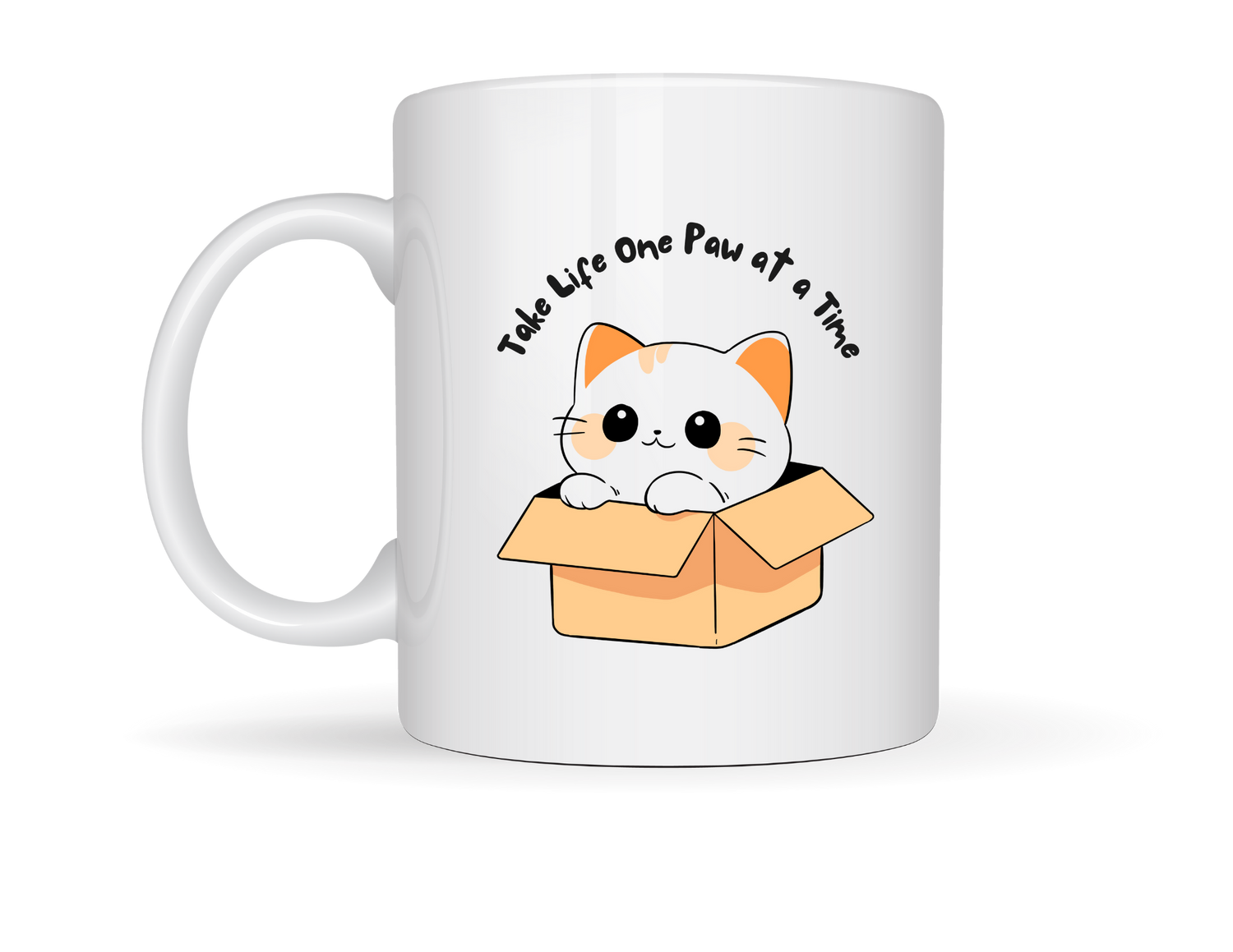 “White ceramic mug featuring a cute cartoon cat in a cardboard box with the phrase ‘Take Life One Paw at a Time.’”